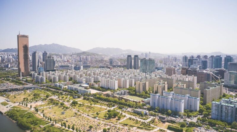 Aerial view showcasing the vibrant cityscape of Seoul with iconic skyscrapers and lush green parks.