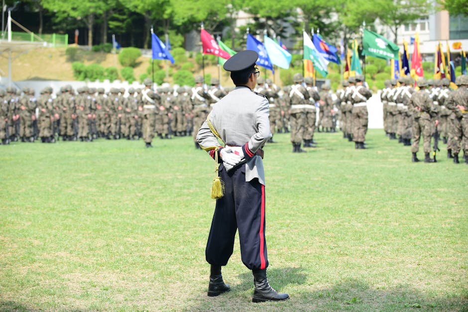 A military officer oversees a formation during a vibrant outdoor ceremony.