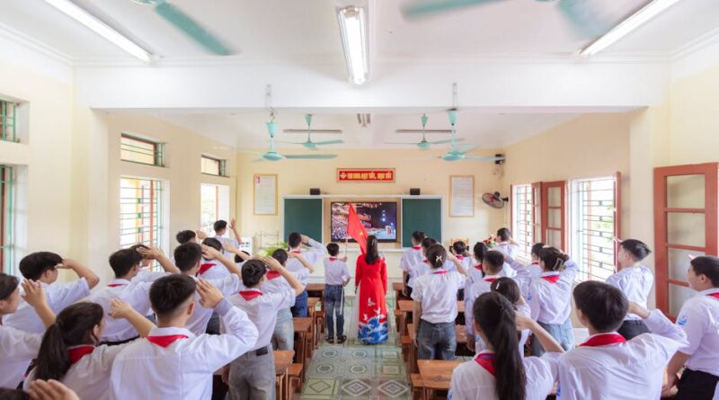 A dynamic classroom scene with students engaged in a collective activity led by a teacher.