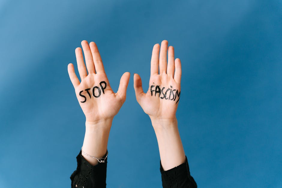 Hands raised against fascism with powerful message on blue background.