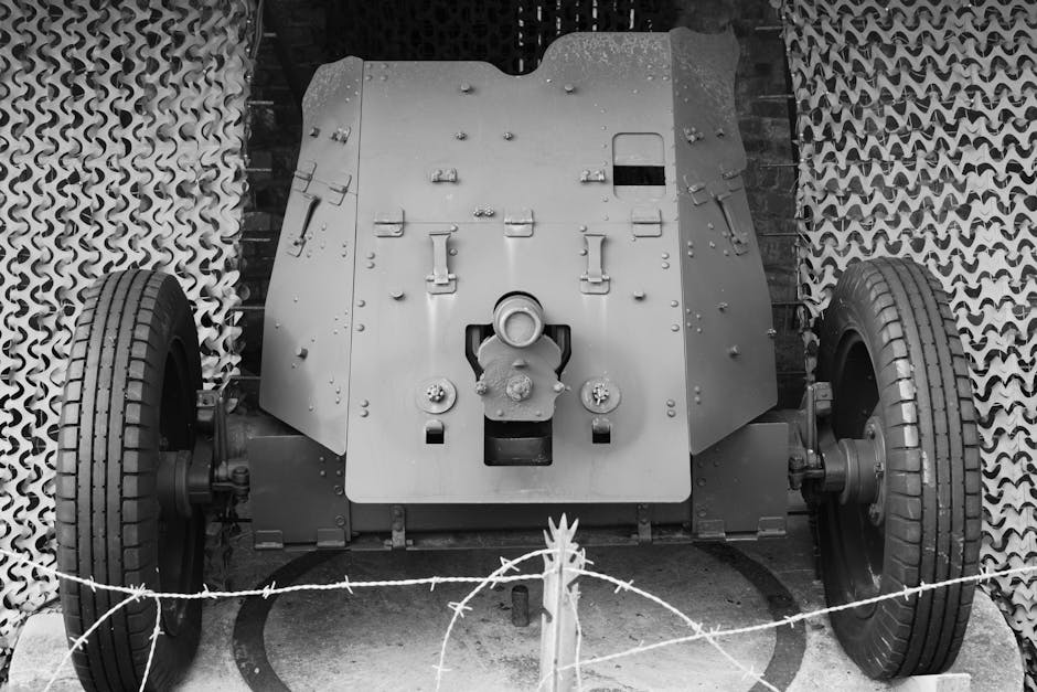 Front view of a World War II anti-tank cannon at a museum in black and white.