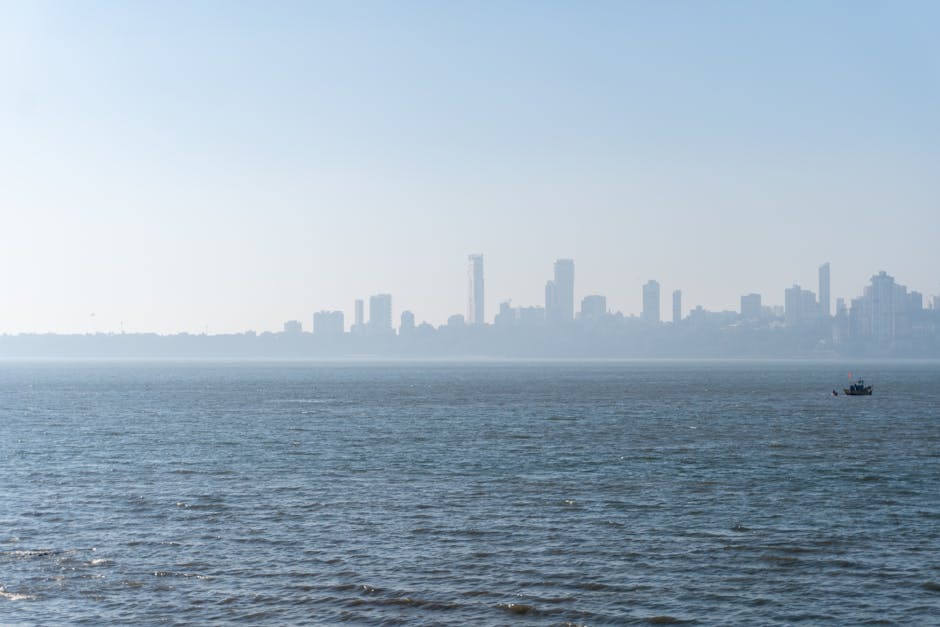 Serene view of Mumbai skyline over the Arabian Sea with distant cityscape.