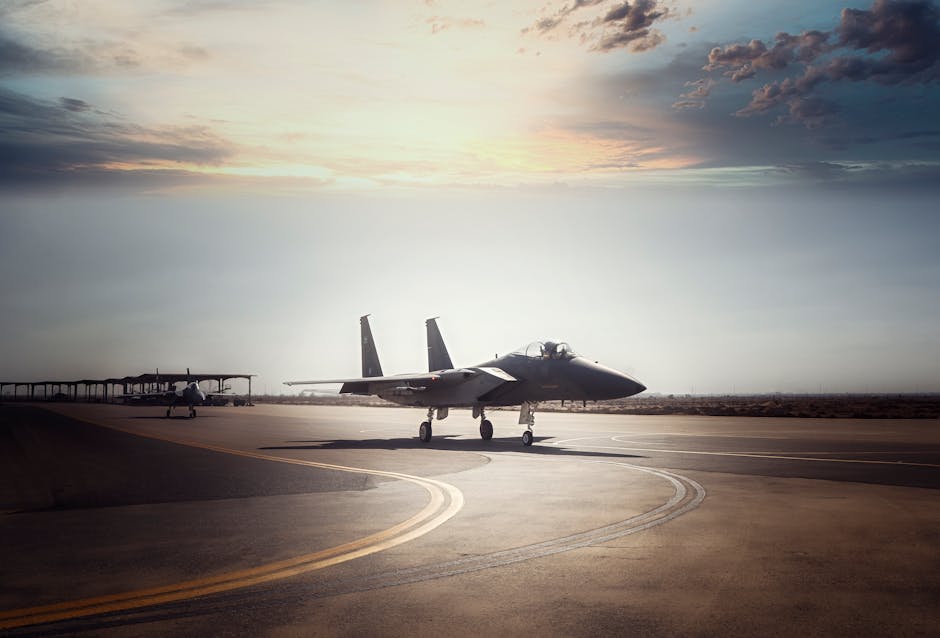 A military fighter jet prepares for takeoff on a runway during sunrise.