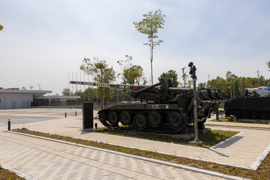 A historic military tank displayed outdoors in a sunny park setting.