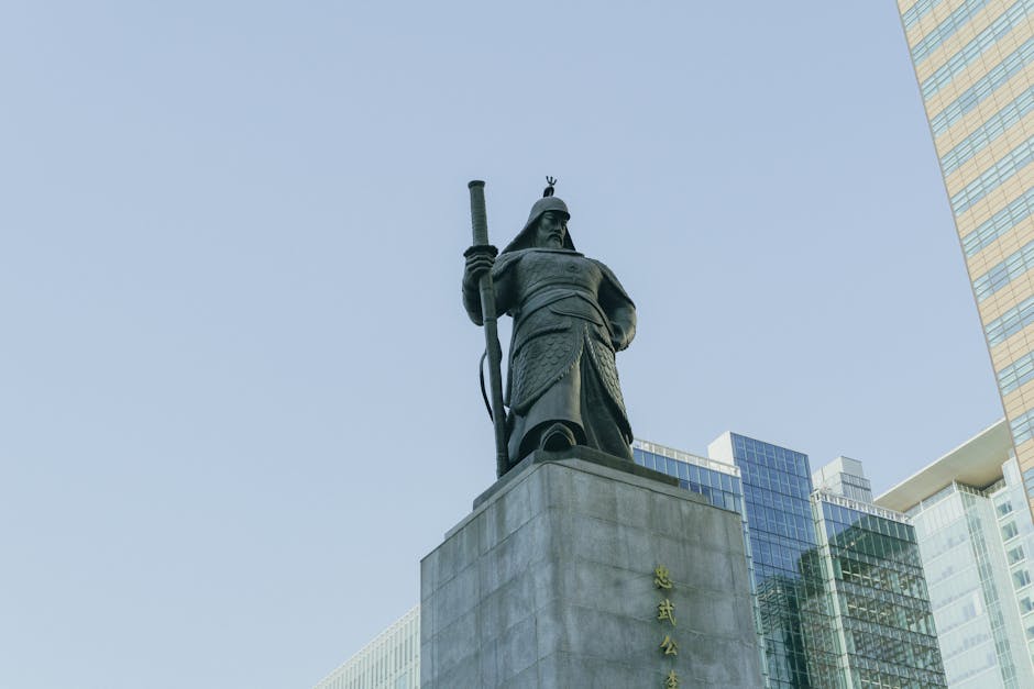 Admiral Yi Sun-sin statue at Gwanghwamun Square, Seoul under a clear sky.