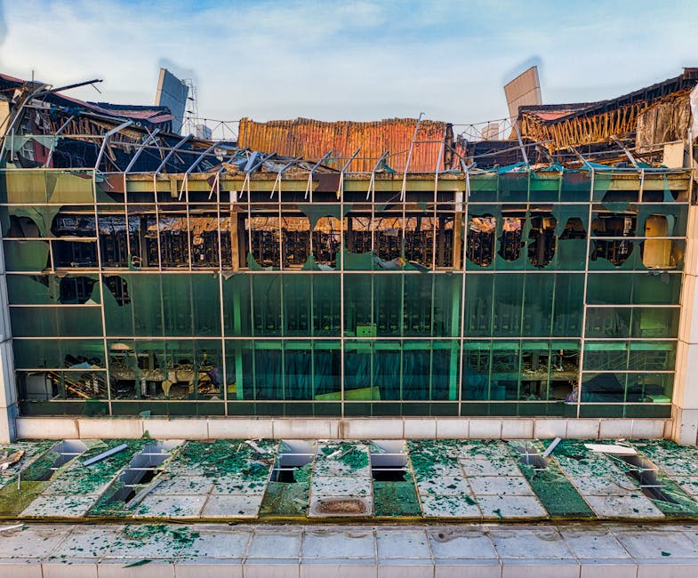 Aerial shot of a damaged building facade with broken glass windows in Banten, Indonesia.