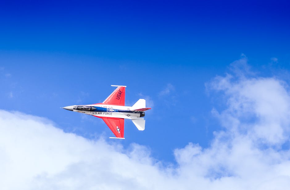 US Air Force jet flying through a clear blue sky showcasing aerial agility.