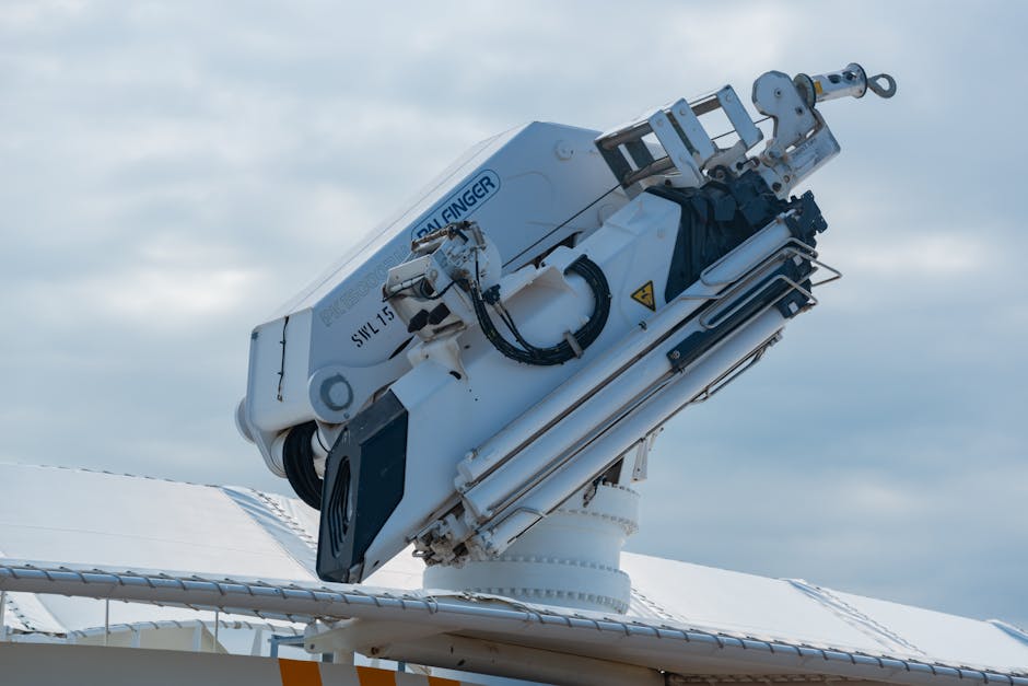 Close-up of a modern naval gun system mounted on a warship deck, with a clear sky background.